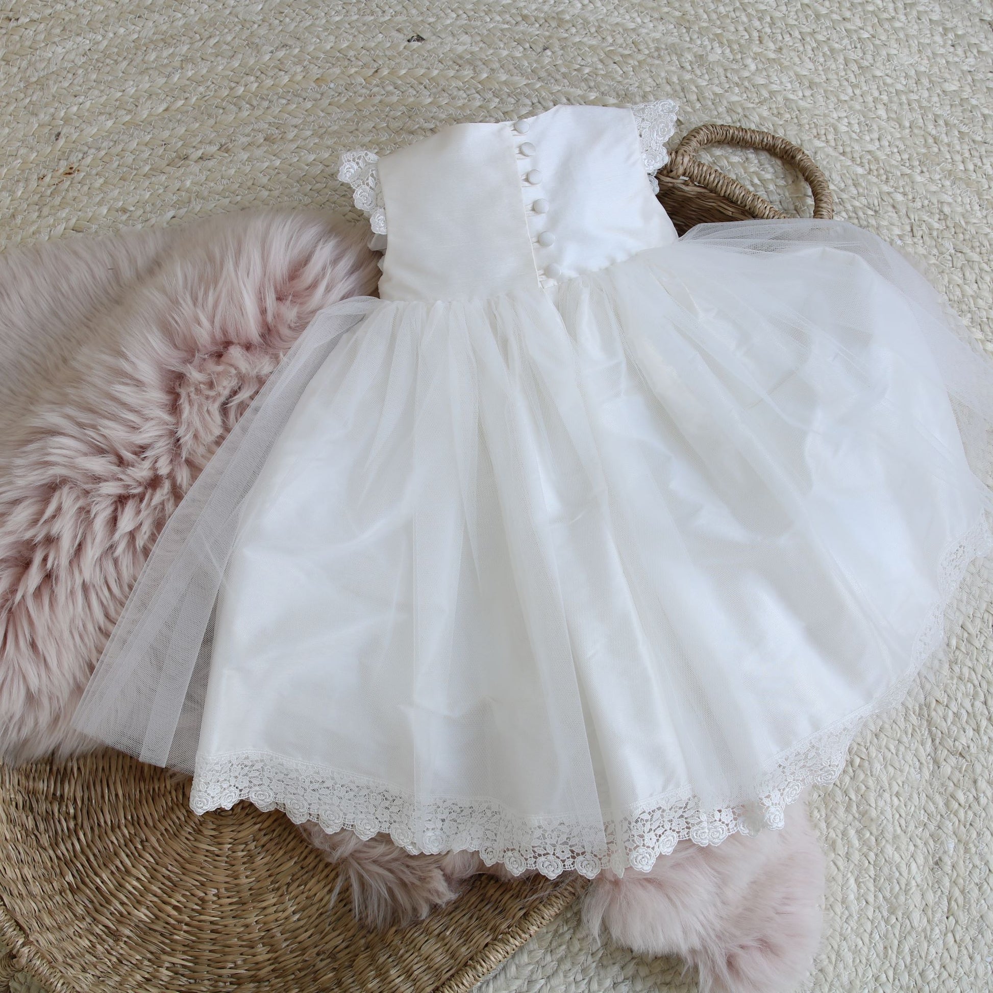 A full view of the back of the Evelyn silk and tulle baby occasion dress featuring button and loop fastenings.