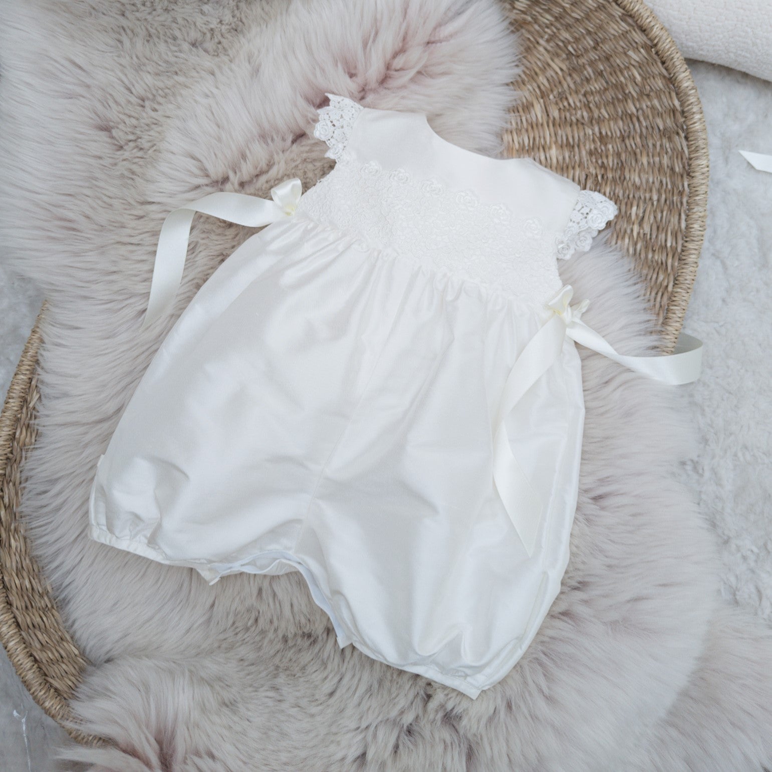 Evelyn girls special occasion or baptism romper in ivory. Shown in its own in a flatlay style