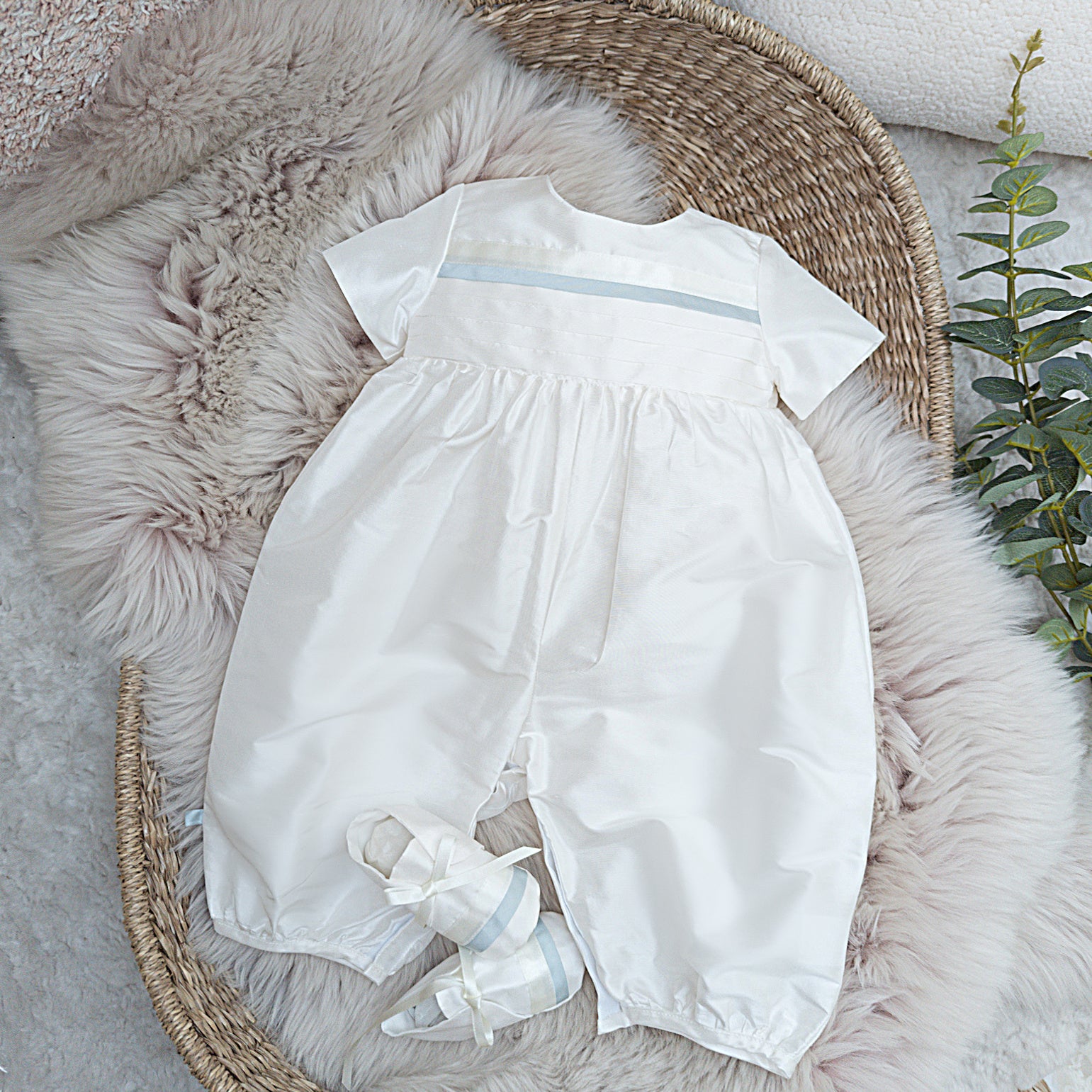 Centred image of the Jack romper and booties in a flatlay design