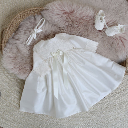 Lara long sleeved baptism dress shown with booties and headband in ivory.