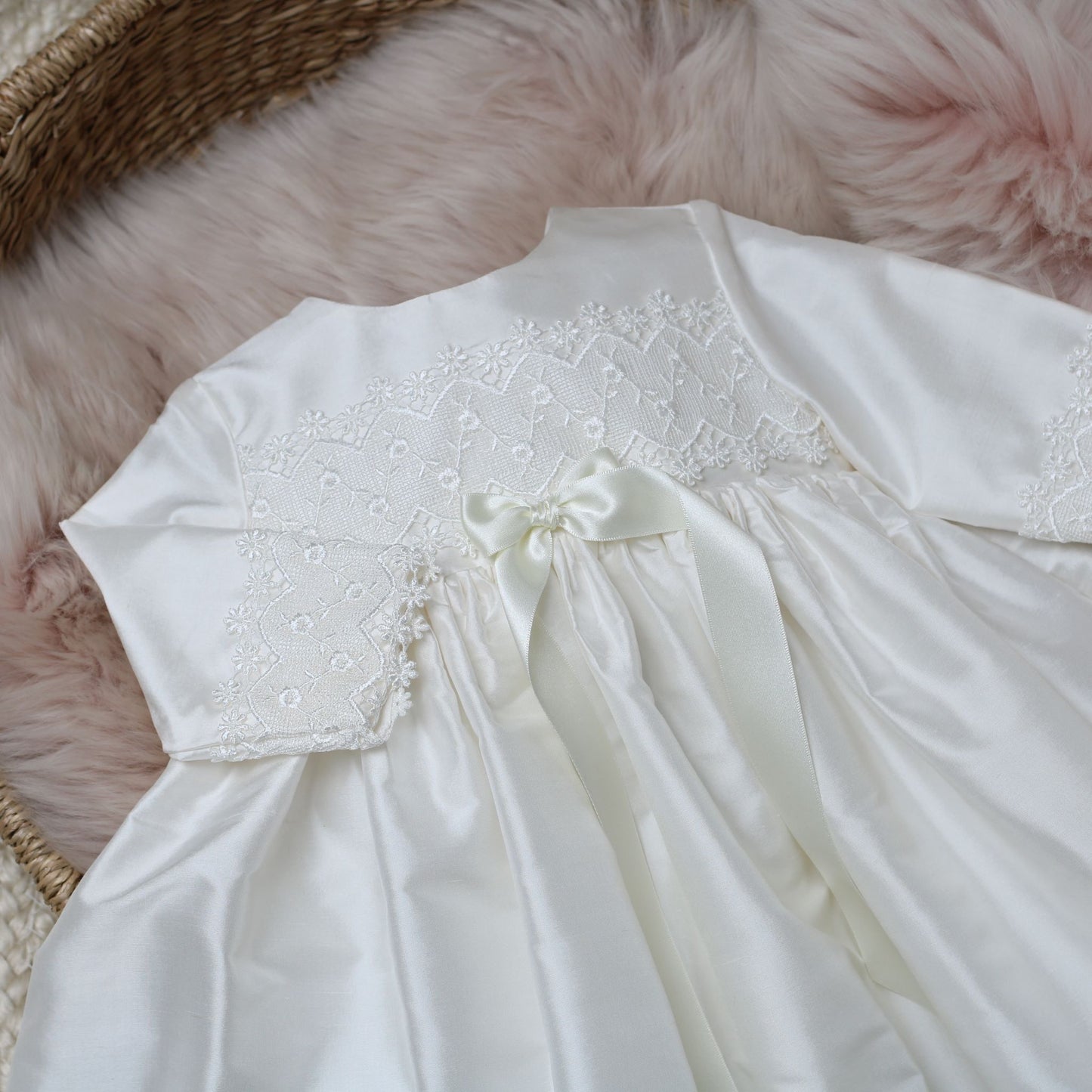 Close up detail of the lace trim on the lara long sleeved baby baptism dress