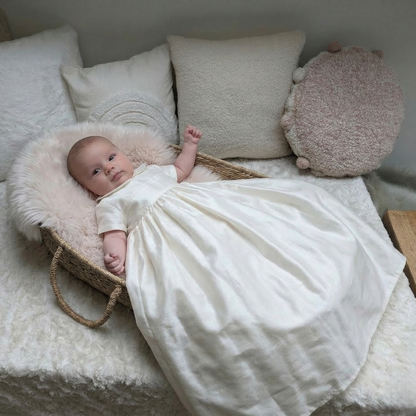 Luke silk christening gown in ivory shown on a baby. The gown has short sleeves and a collar