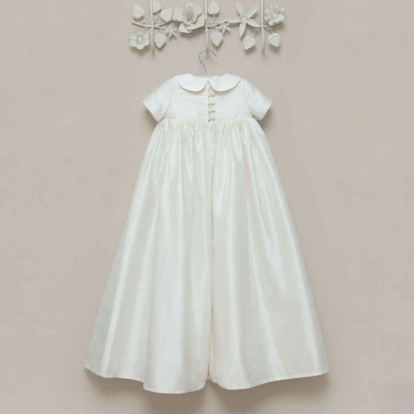 The back view of the Luke ivory silk christening gown showing the buttons with loop closures