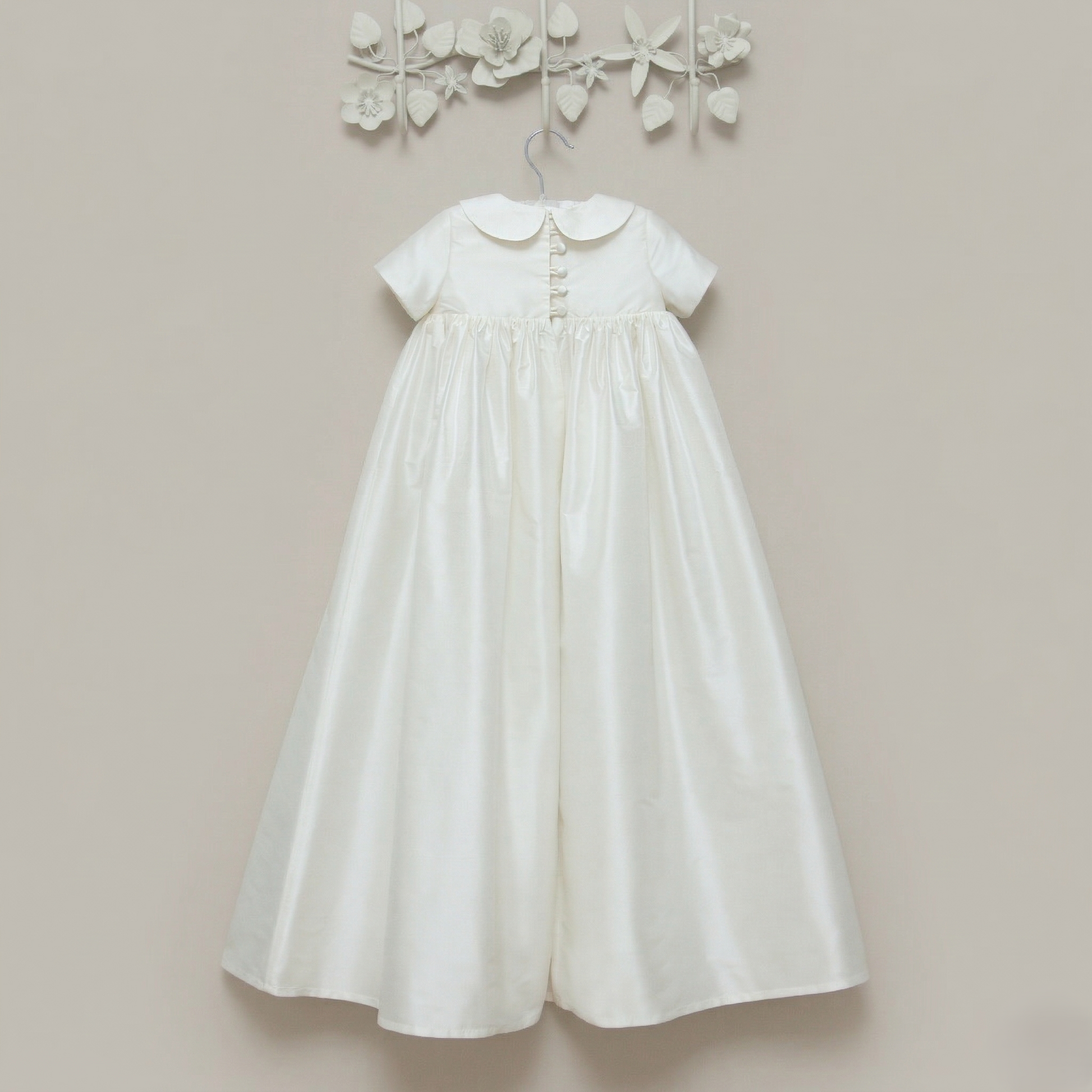The back view of the Luke ivory silk christening gown showing the buttons with loop closures