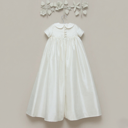 The back view of the Luke ivory silk christening gown showing the buttons with loop closures