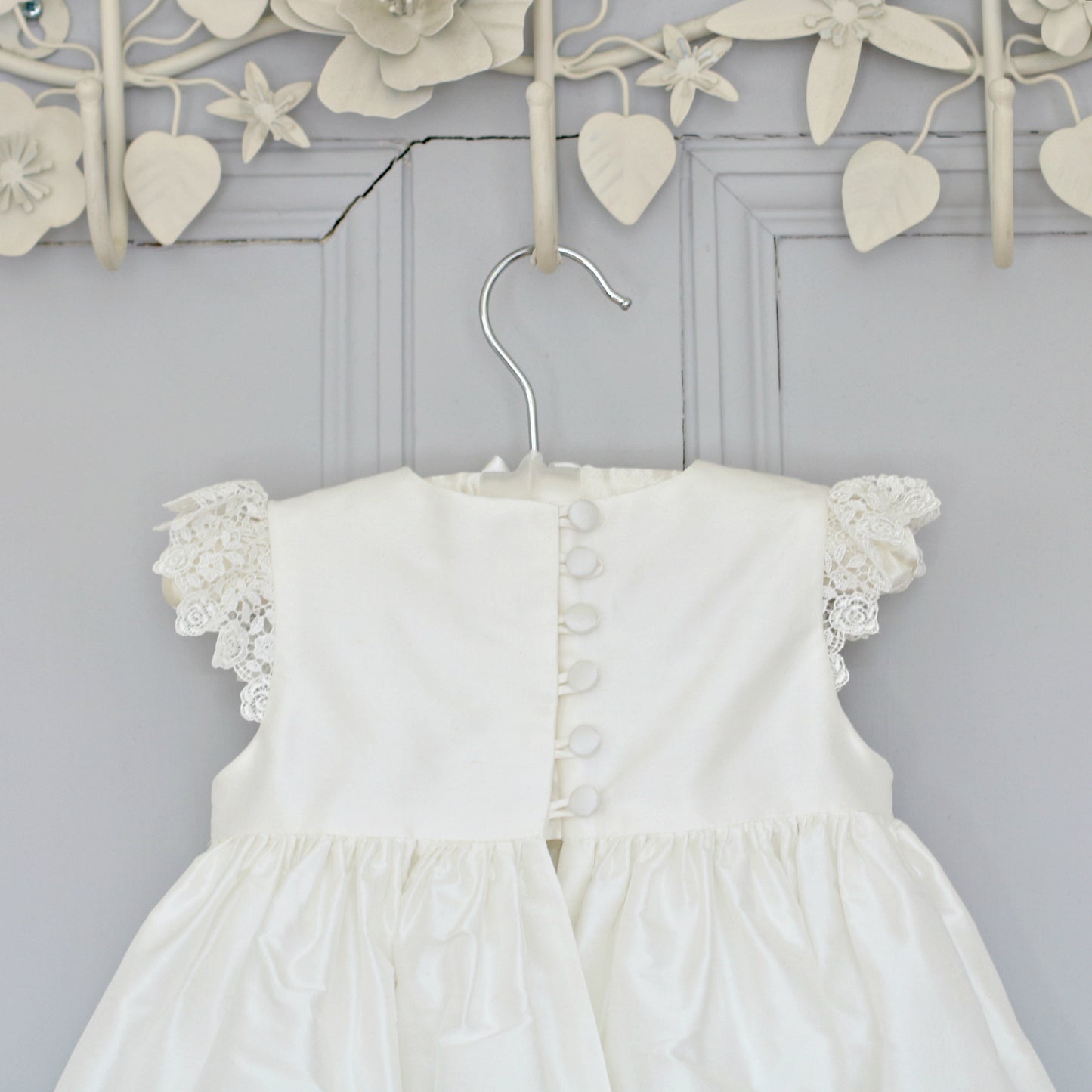 Close-up of the Rachel Christening Gown bodice showing delicate silk-covered buttons and loop fastenings