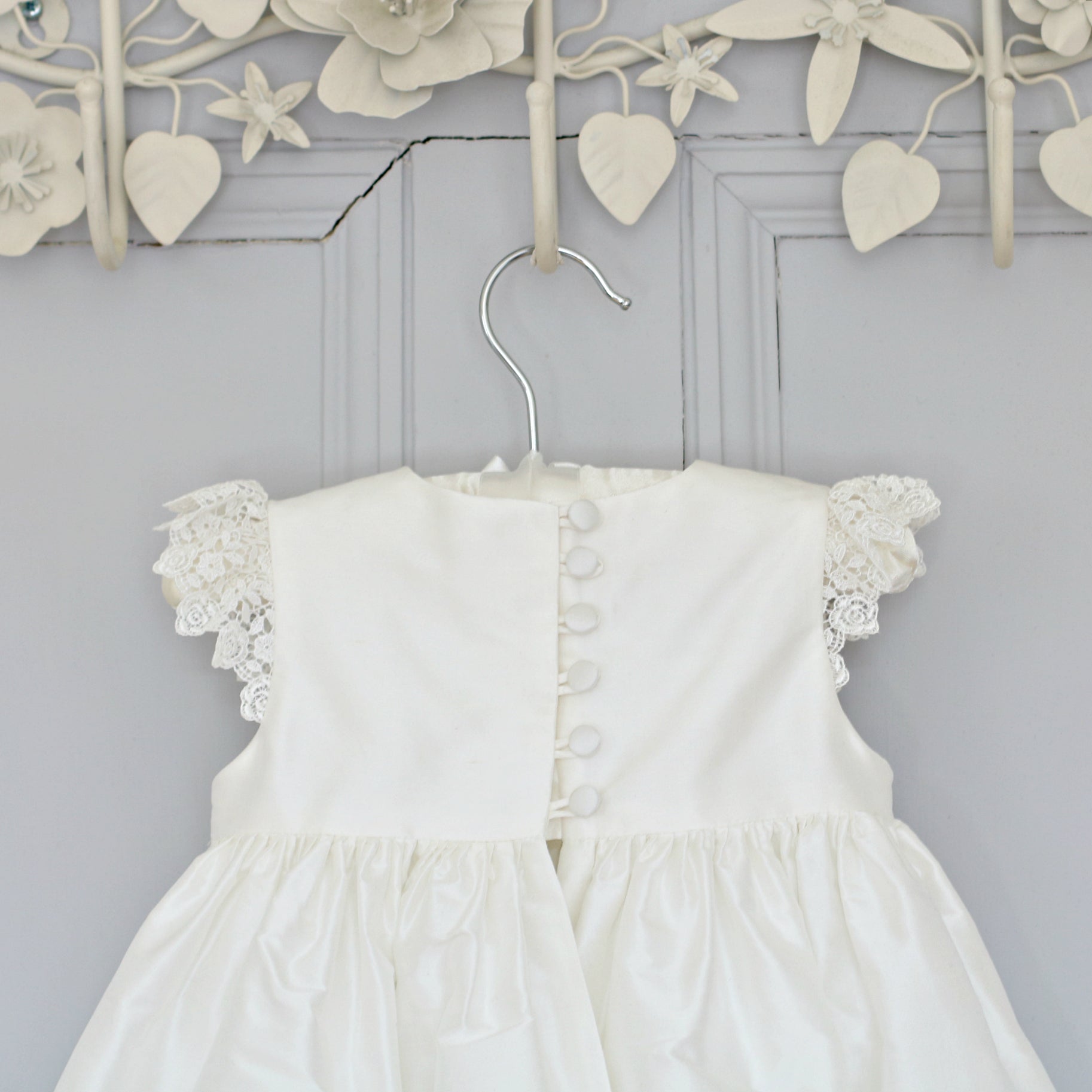 Close-up of the Rachel Christening Gown bodice showing delicate silk-covered buttons and loop fastenings