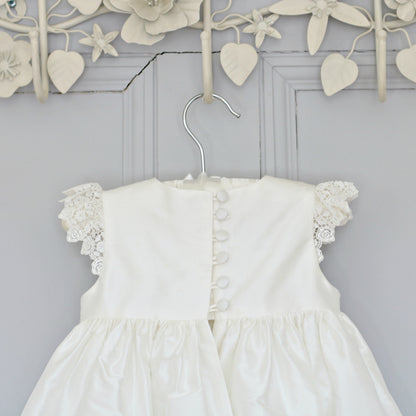 Close-up of the Rachel Christening Gown bodice showing delicate silk-covered buttons and loop fastenings