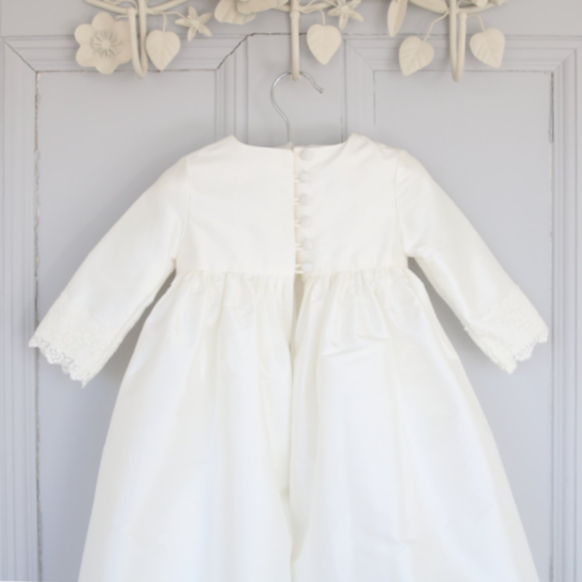 close up of the Rebekah christening gown back detail showing buttons and loops.