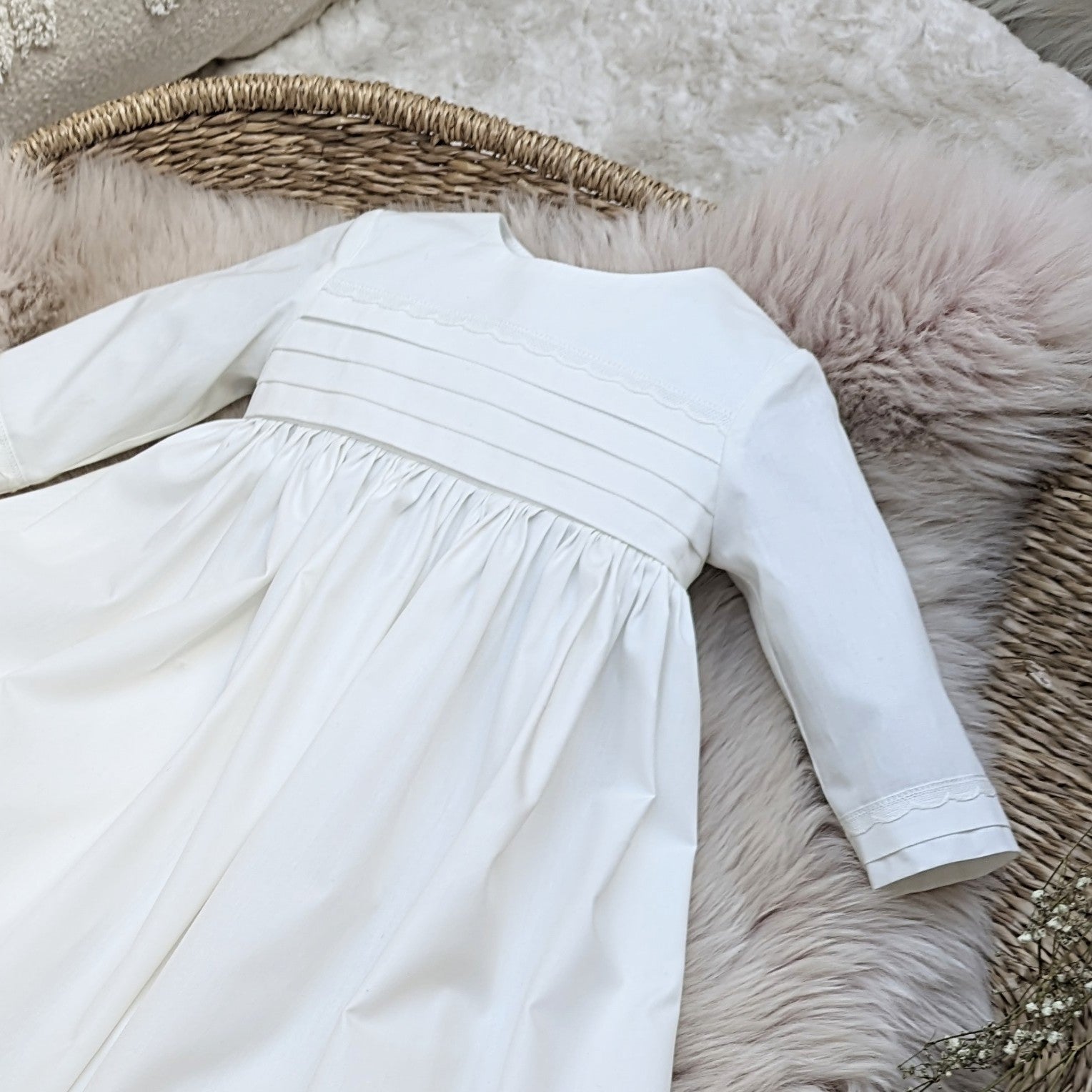 front view of the Rome christening gown bodice featuring tucks on the bodice and sleeves