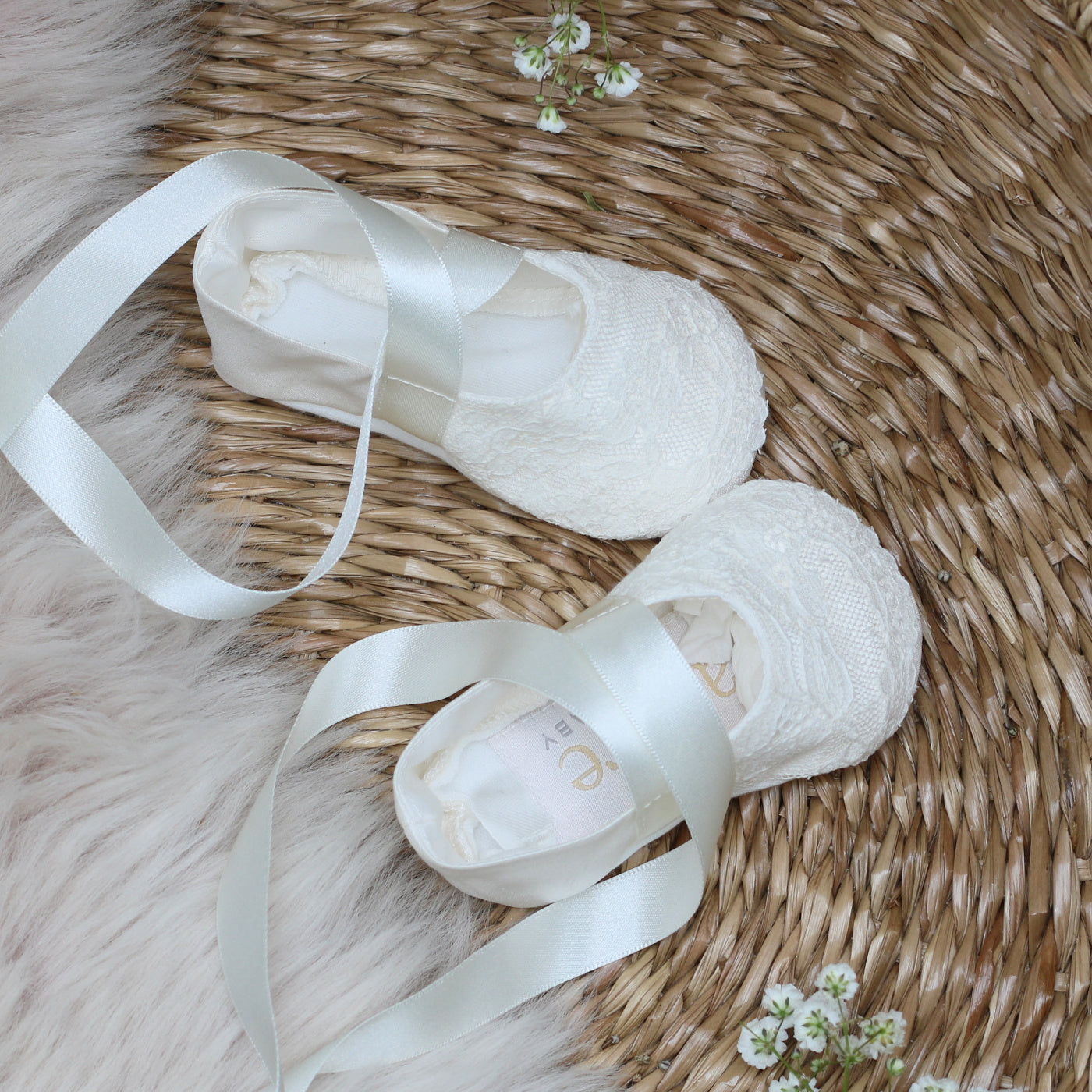 Close up image of the Scarlett silk and Valenciennes lace christening booties shown from above