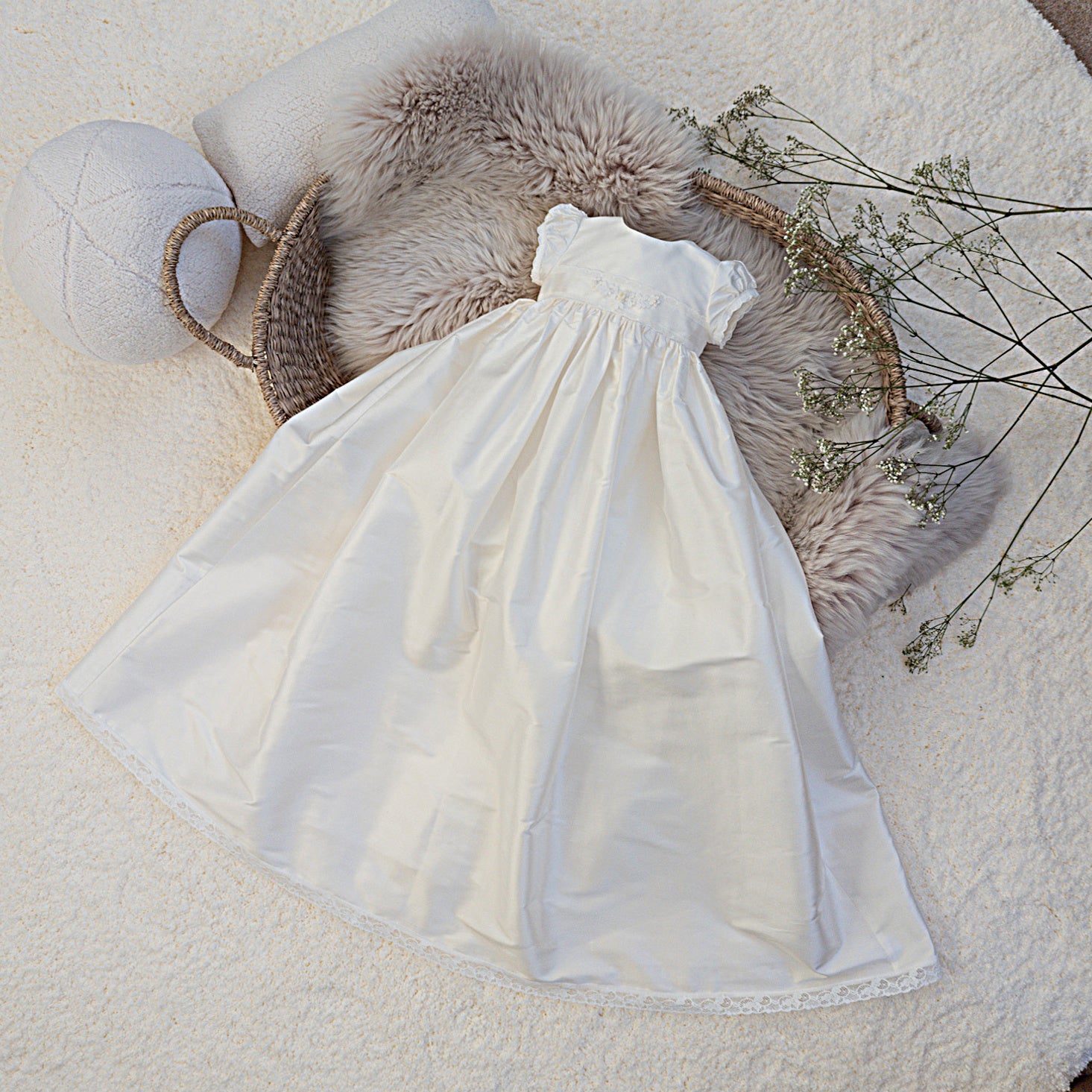 White dress on a textured surface with decorative elements