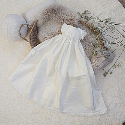 White dress on a textured surface with decorative elements