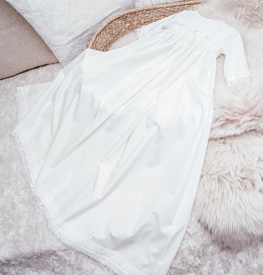 White fabric draped over a woven basket on a soft surface