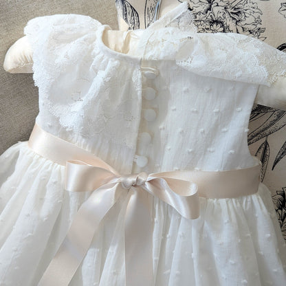 Close up of the back bodice on the Eliana baptism gown, showing the six covered buttons and delicate loop fastenings.