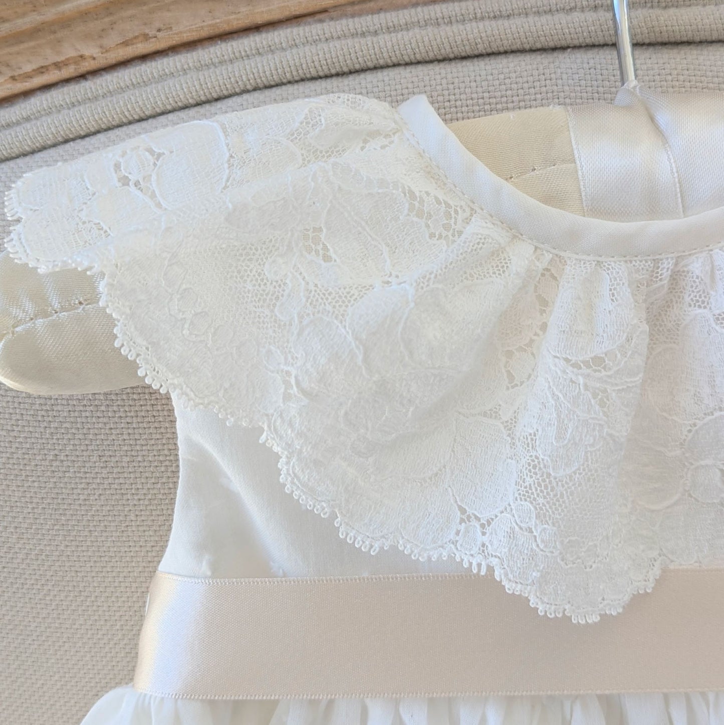 Close up of the frill style French lace collar on the sleeveless Eliana christening gown.