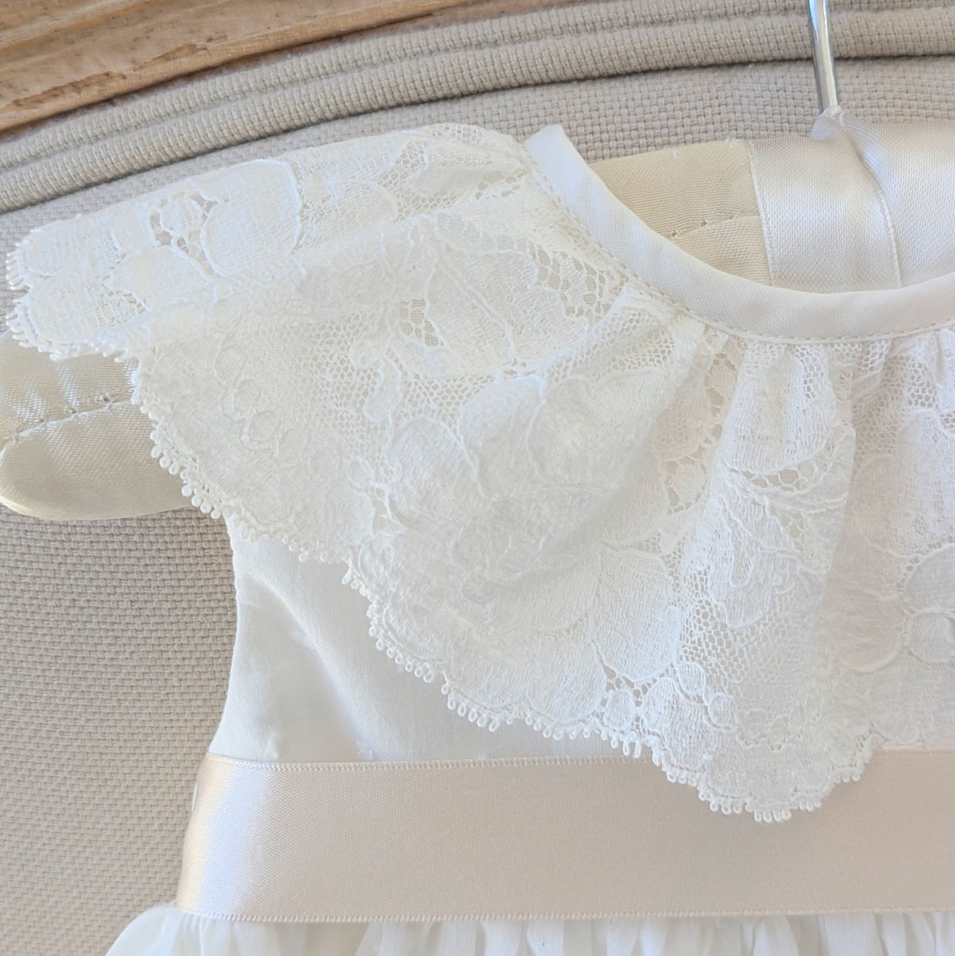 Close up of the frill style French lace collar on the sleeveless Eliana christening gown.