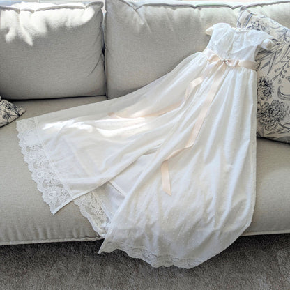 Back view of the Eliana christening gown highlighting the traditional open back skirt, fully lined in cotton.