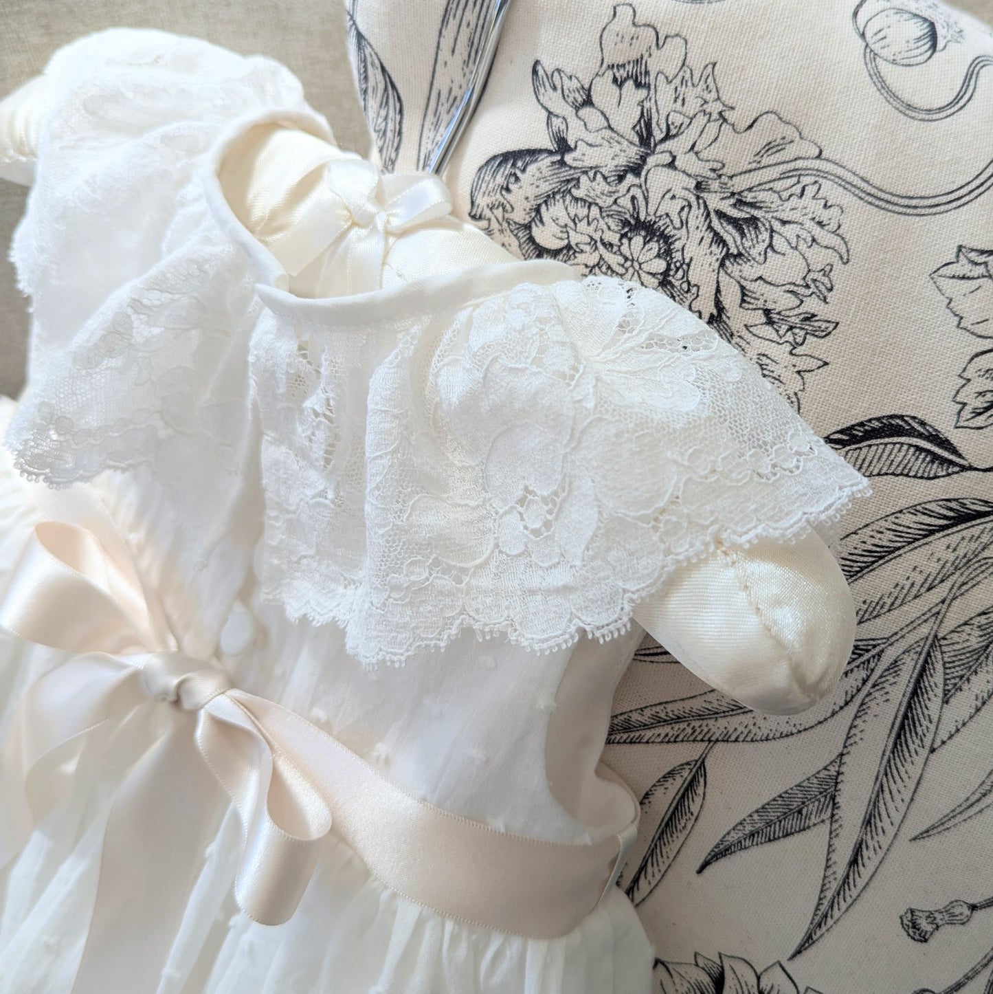 Close up of the frill style French lace collar on the back of the sleeveless Eliana christening gown.