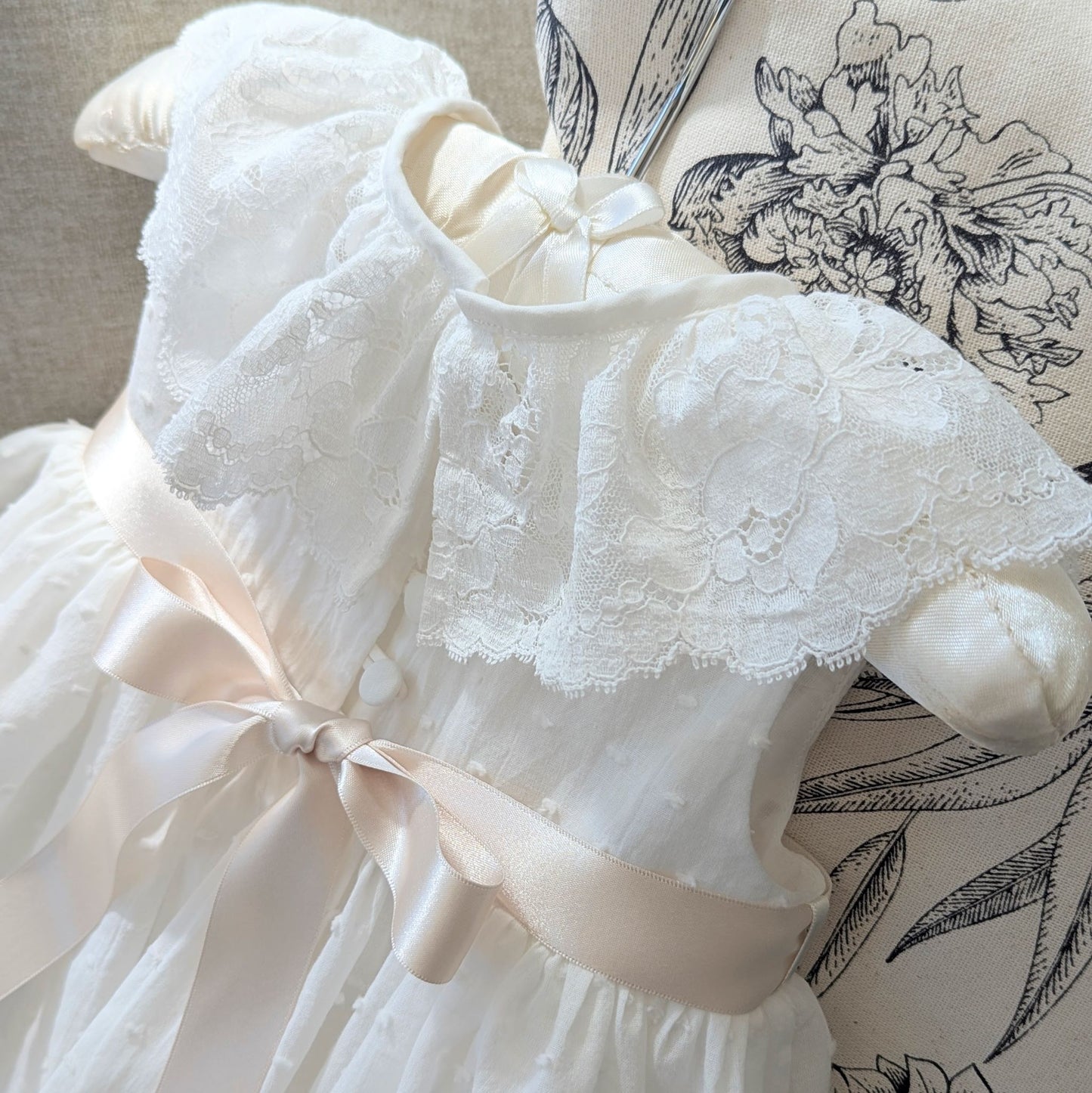 Close up of the frill style French lace collar on the sleeveless Eliana baptism gown.
