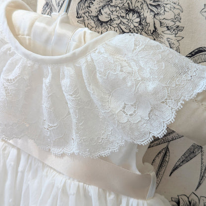 Close up of the frill style French lace collar on the sleeveless Eliana ceremony gown.