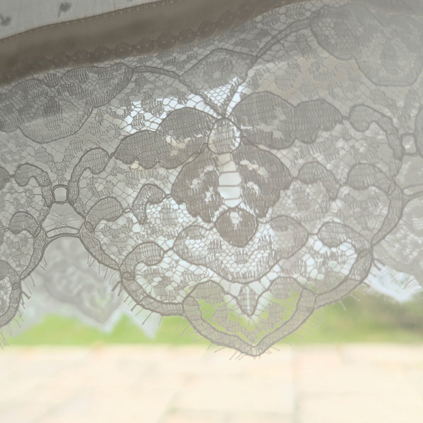 close up lace detail of the hem of the Isabella baby baptism gown made rom cotton