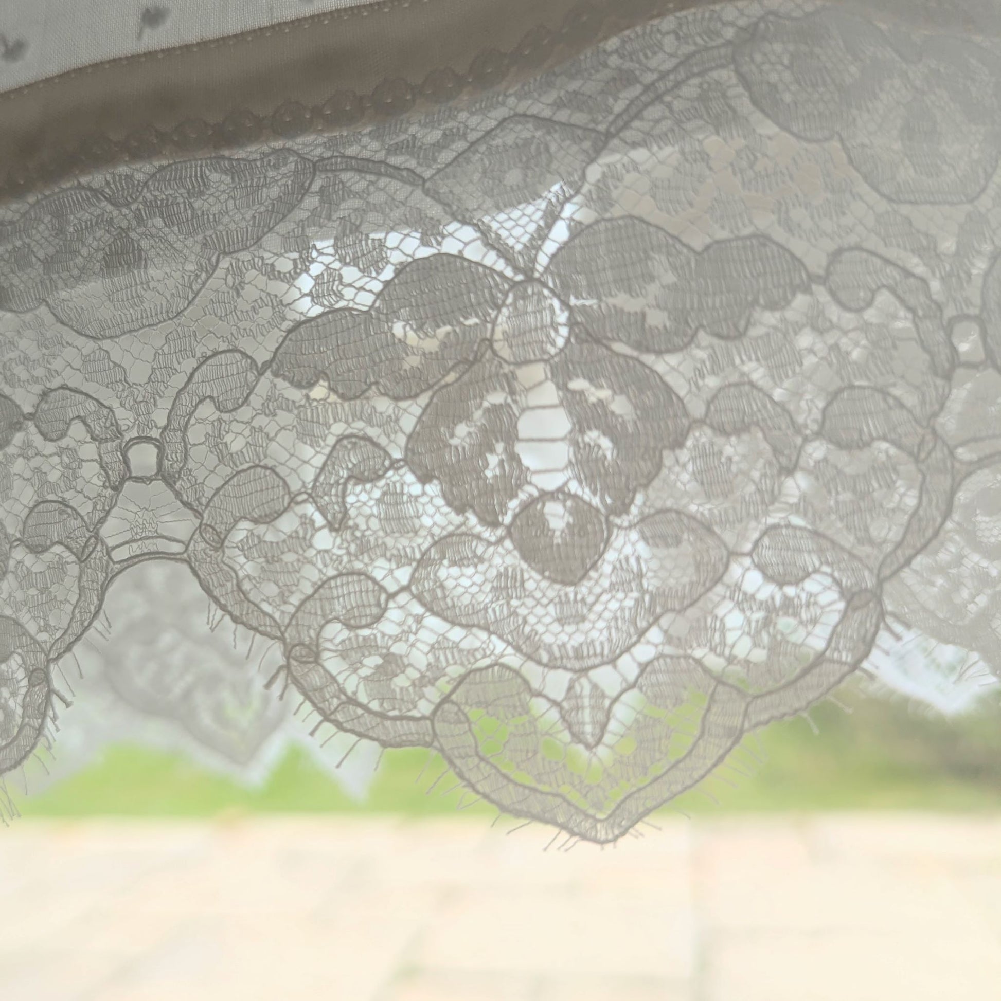 close up lace detail of the hem of the Isabella baby baptism gown made rom cotton