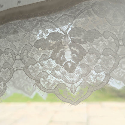 close up lace detail of the hem of the Isabella baby baptism gown made rom cotton