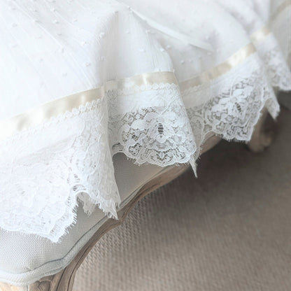 Macro view of the high-quality French lace hem details on the Isabella heirloom gown.