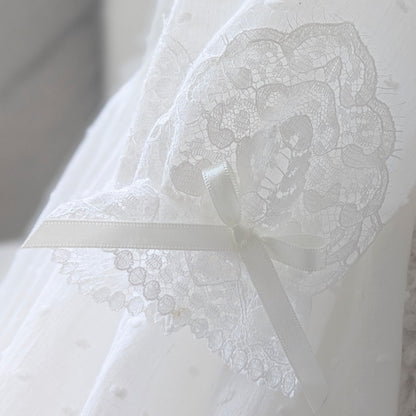 Close-up of the elegant long sleeves on the Isabella christening gown, featuring fine French lace-trimmed cuffs and a delicate handmade bow.
