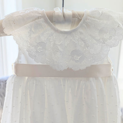 The front bodice and collar detail of the sleeveless Eliana christening gown showing the satin sash
