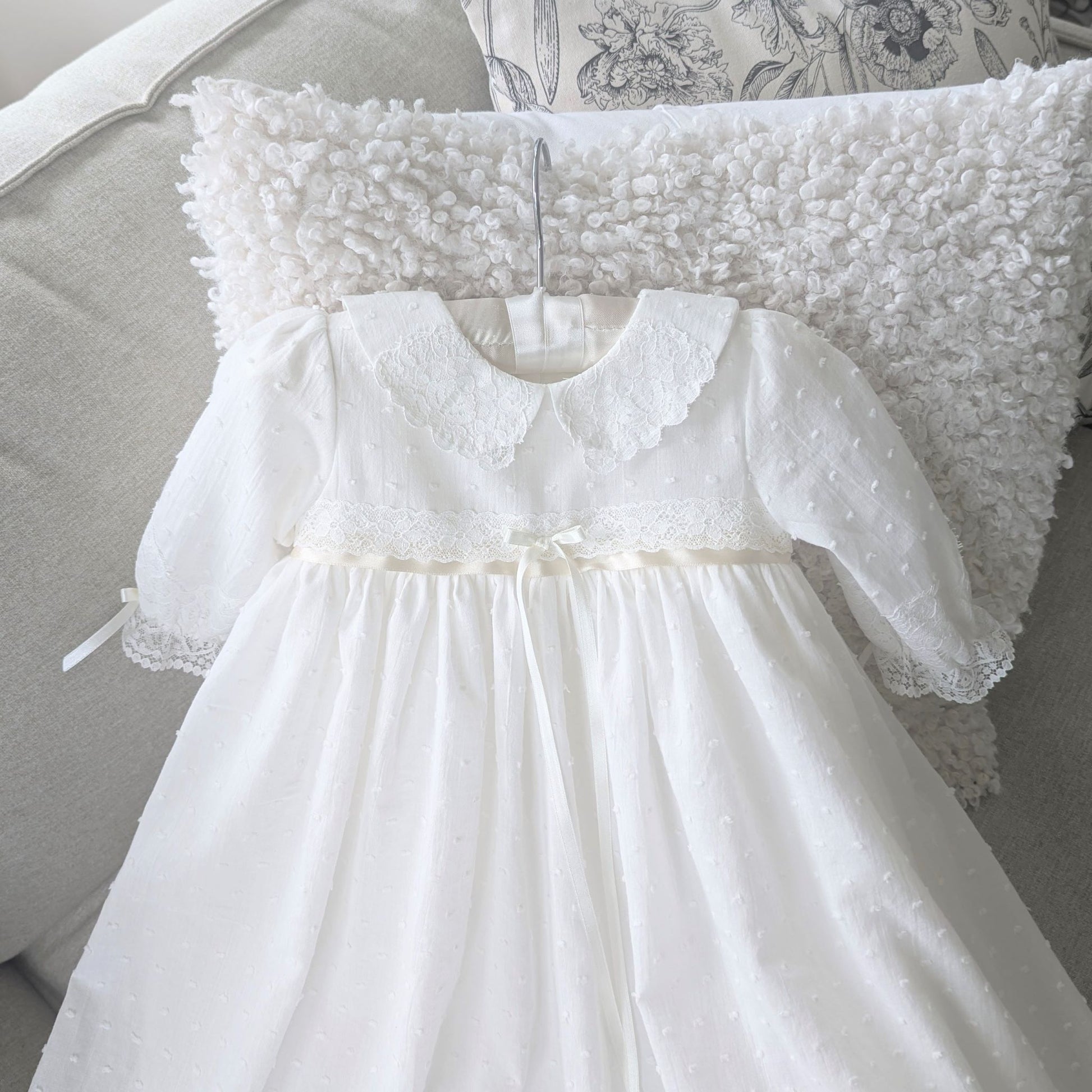 Close-up of the contrasting darker ivory satin ribbon and lace at the waist of the Isabella gown.