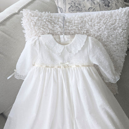 Close-up of the contrasting darker ivory satin ribbon and lace at the waist of the Isabella gown.
