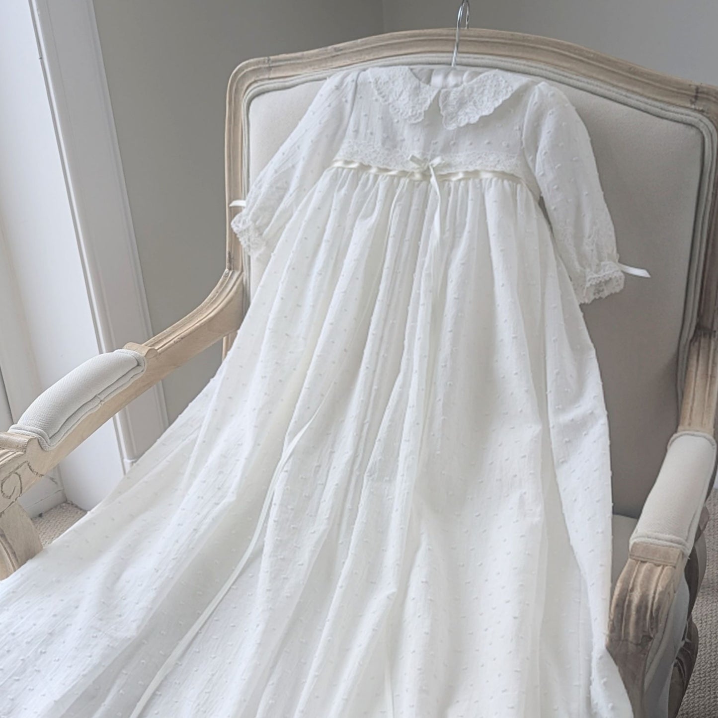 Traditional yet modern long ivory christening gown with long sleeves and collar with lace detail.